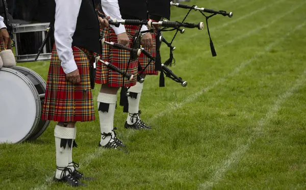 A Scottish pipe band waits on the pitch at the Scottish Highland Games in Crieff