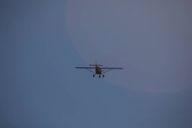 A small plane flies over the Fervenza reservoir in Dumbria with a blue sky clipart