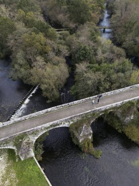 Aerial view of Ponte Ledesma bridge of medieval origin over the Ulla river in Boqueixon, border between the provinces of A Corunha and Pontevedra clipart