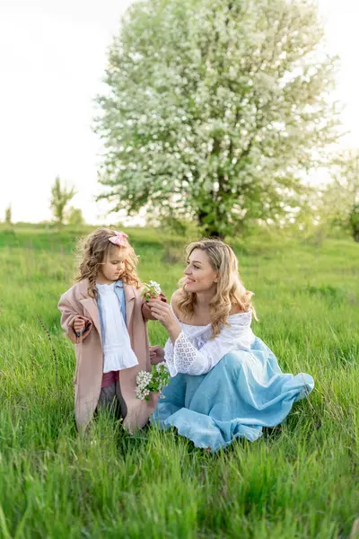 Young Beautiful Mother Her Little Daughter Picking Flowers Meadow Royalty Free Stock Images