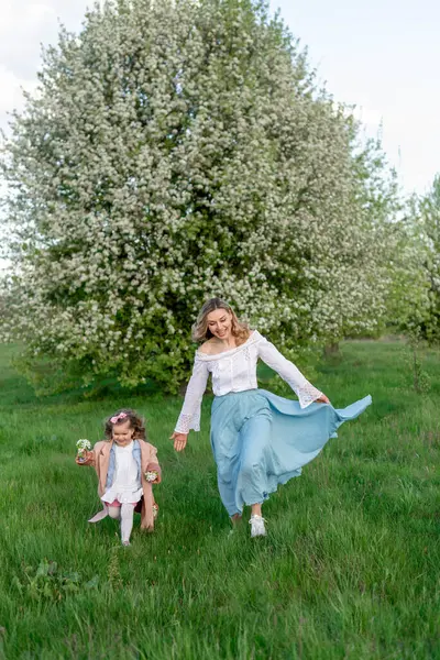 Mother Little Daughter Walk Green Meadow Blooming Pear Tree Royalty Free Stock Images