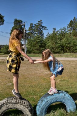 Okul çağındaki çocuklar şehir dışındaki bir çam ormanının yakınındaki bir oyun alanında oynuyorlar. Yaz tatili