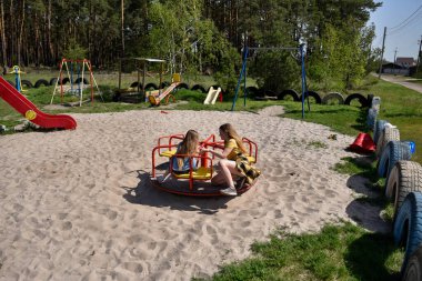 Okul çağındaki çocuklar şehir dışındaki bir çam ormanının yakınındaki bir oyun alanında oynuyorlar. Yaz tatili