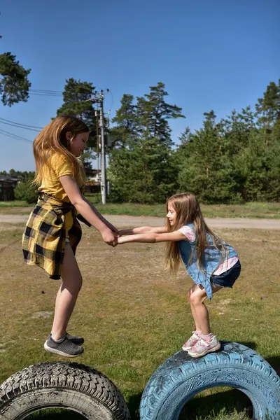 Okul çağındaki çocuklar şehir dışındaki bir çam ormanının yakınındaki bir oyun alanında oynuyorlar. Yaz tatili