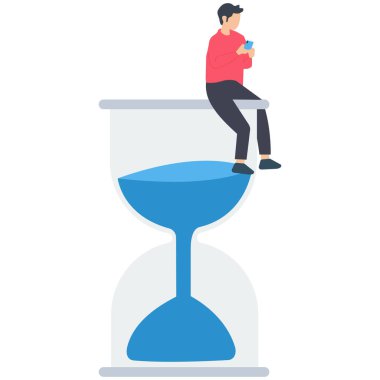 Akıllı telefonlara bağımlı bir adam, oyun zamanı, akıllı telefonlar kullanarak zaman kaybı, gece geç saatlere kadar cep telefonu bağımlılığı, akıllı telefon kullanarak kum saatinde oturan adam..