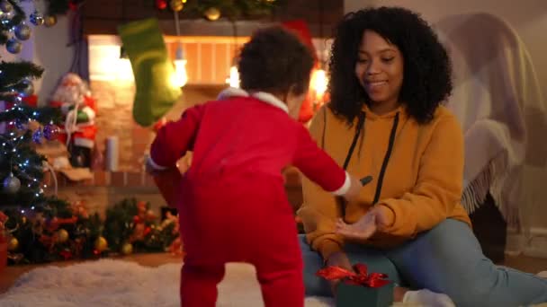 Smiling Young African American Mother Sitting Fireplace Christmas Eve Toddler — Stock Video