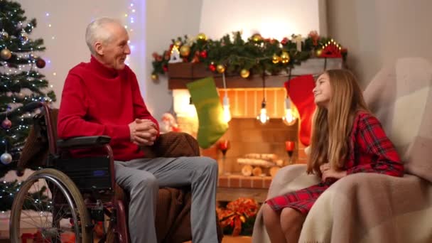 Relaxed Happy Caucasian Grandfather Granddaughter Talking Smiling Sitting Fireplace Christmas — Stock Video