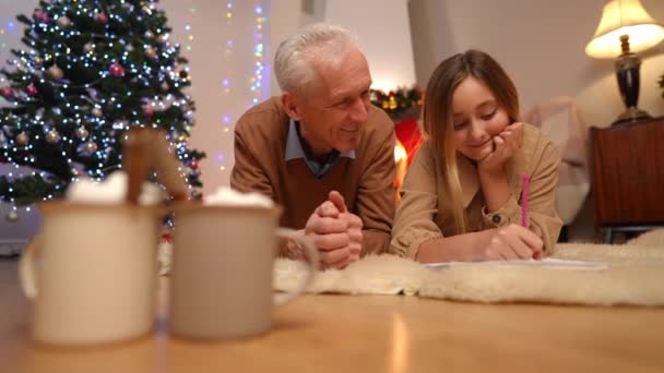 Avô Sorridente Conversando Com Neta Escrevendo Carta Para Papai Noel — Vídeo de Stock