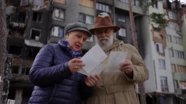 Ukrayna 'da bombalanmış bir binanın önünde duran eski fotoğrafları izleyen hayal kırıklığına uğramış yaşlı adam ve kadın konuşuyor. Bunalımlı çift dışarıdaki anılarını anımsıyor. Askeri işgal ve umut kavramı
