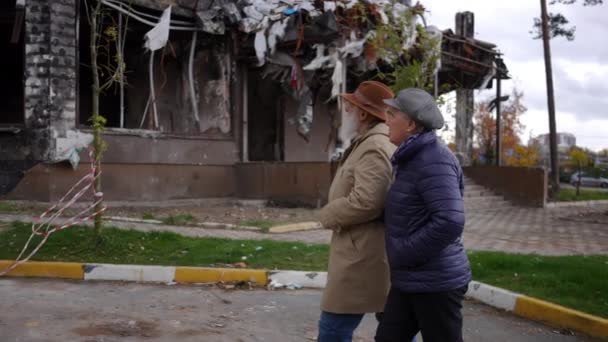 Vista Lateral Seguimiento Disparo Pareja Ancianos Caminando Ciudad Ruinas Ucrania — Vídeos de Stock