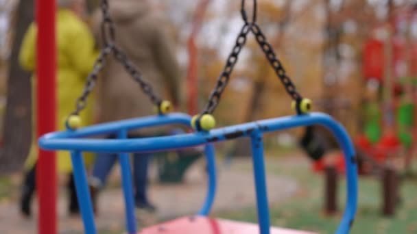 Close Swings Playground Blurred Senior Couple Walking Away Slow Motion — Stock Video