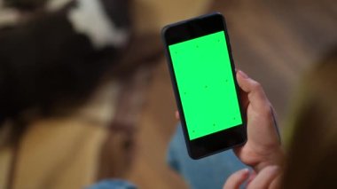 Yakın plan krom renkli akıllı telefon ekranı ve dövmeli kadın el sürgüsü. Çevrimiçi uygulama sörfü internet sitesini yeşil ekranda kullanan tanımlanamayan Kafkas genç kadın