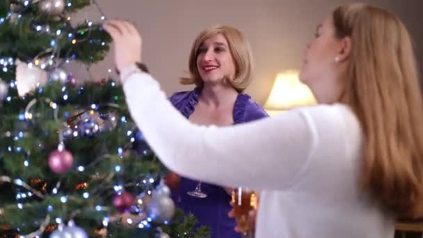 Happy Gender Fluid Woman Talking Female Friend Standing Christmas Tree — Stock Video