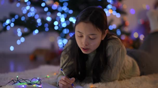 Young Charming Asian Slim Woman Teeth Braces Writing Letter Santa — Stock Video