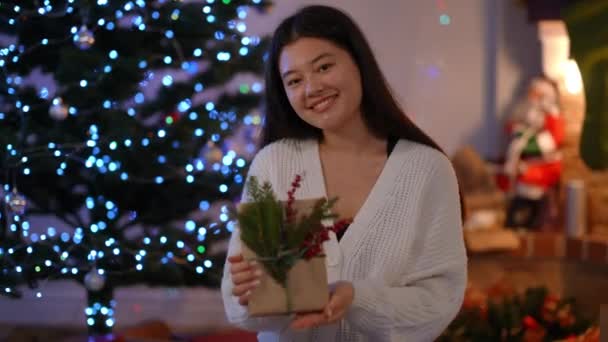 Medium Shot Charming Asian Young Woman Showing Christmas Gift Smiling — Stock Video