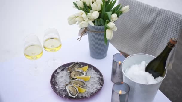 在冬季室外 高角度的香槟酒牡蛎花和雪白的蜡烛 情人节浪漫的晚餐在寒冷的二月的一天 — 图库视频影像