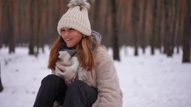 兴奋的少女拍手叫好笑 坐在雪橇上 就像一个拉雪橇的无法辨认的男孩 快乐满足的白种人青少年与朋友共度寒假 — 图库视频影像