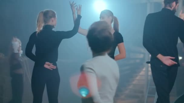 Young Women Men Holding Hands Spinning Walking Backlit Light Theater — Video
