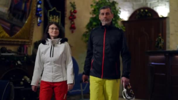 Confident Mature Man Woman Ski Costumes Walking Winter Resort Lobby — Vídeo de Stock