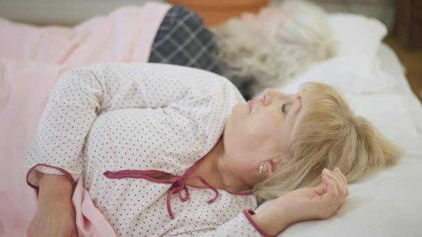 Sad Senior Wife Argued Husband Lying Bed Looking Back Sighing — Video