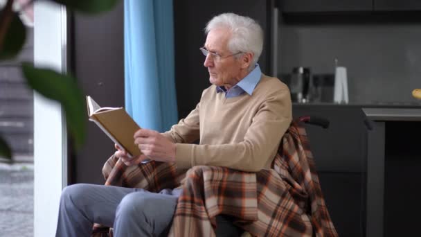 Absorbed Concentrated Senior Man Reading Book Taking Eyeglasses Looking Out — Video Stock