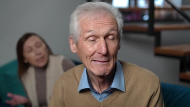 Close Senior Husband Looking Camera Grimacing Furious Wife Yelling Background — Stok video