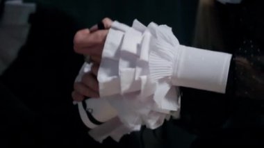 Close-up unrecognizable theater actress putting on wrist ruff indoors. Young Caucasian woman getting ready for performance. Acting and show concept
