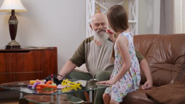 Smiling Senior Man Laughing Cute Girl Applying Make Putting Hair — Stock Video