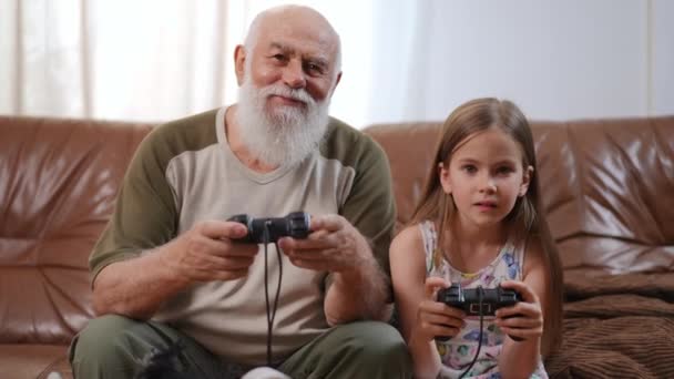 Relaxed Happy Grandfather Granddaughter Gaming Smiling Sitting Comfortable Couch Living — Wideo stockowe