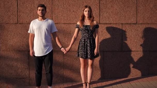 Zoom Loving Millennial Couple Holding Hands Standing Brown Wall Looking — Stockvideo
