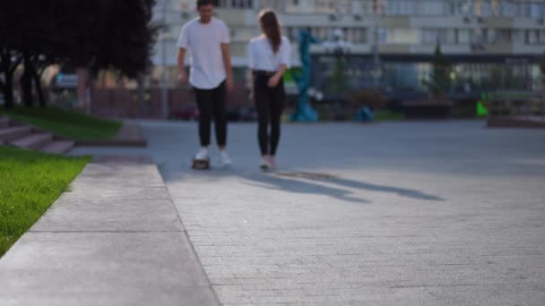 Blurred Young Couple Riding Skateboard Walking City Street Slow Motion — Stockvideo