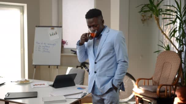 Young Successful African American Businessman Standing Home Office Drinking Tea — Stockvideo