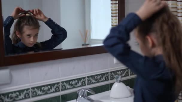 Confident Beautiful Schoolgirl Making Ponytail Admiring Reflection Mirror Home Bathroom — 图库视频影像