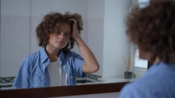 Reflection Bathroom Mirror Concentrated Boy Touching Curly Hair Thinking Cute — Vídeos de Stock