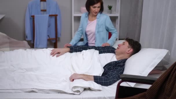 Caucasian Man Disability Lying Bed Talking Woman Turning Body Stroking — Stock Video