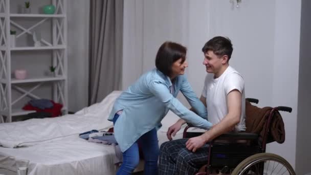 Side View Portrait Loving Woman Helping Man Wheelchair Changing Clothes — 图库视频影像