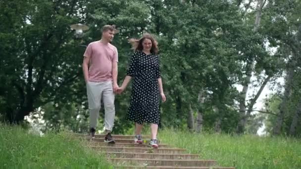 Joyful Young Couple Running Downstairs Park Holding Hands Smiling Wide — Vídeos de Stock