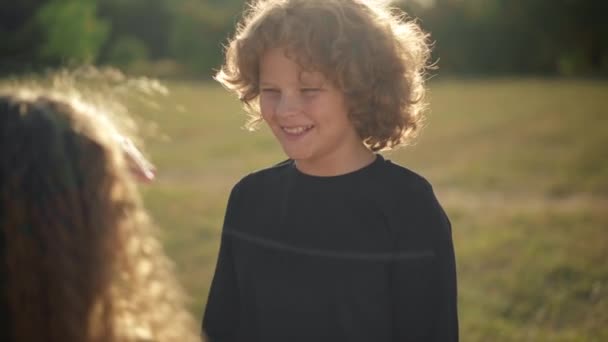 Portrait Charming Curly Haired Boy Sunshine Smiling Unrecognizable Girl Touching — Stok video