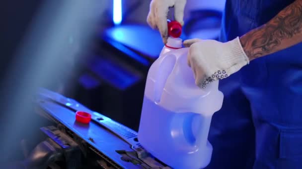 Unrecognizable Man Attaching Pouring Spout Tank Antifreeze Liquid Indoors Young — Stockvideo