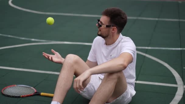 Confident Smiling Sportsman Sunglasses Juggling Tennis Ball Slow Motion Sitting — Stock Video