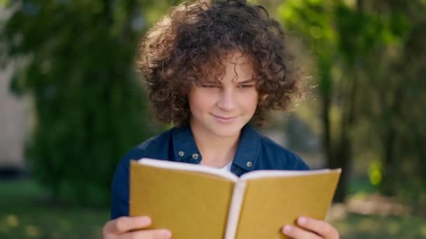 Lächelnder Smarter Kaukasischer Junge Der Laut Auf Dem Sonnigen Schulhof — Stockvideo
