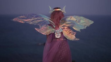 Akdeniz 'deki uçurumun kenarında karanlıkta dikilen peri elbiseli kadın kurşun ışıkla keman çalmaya başlıyor. Orta ölçekli yetenekli Kafkasyalı müzisyen yavaş çekimde performansı seviyor