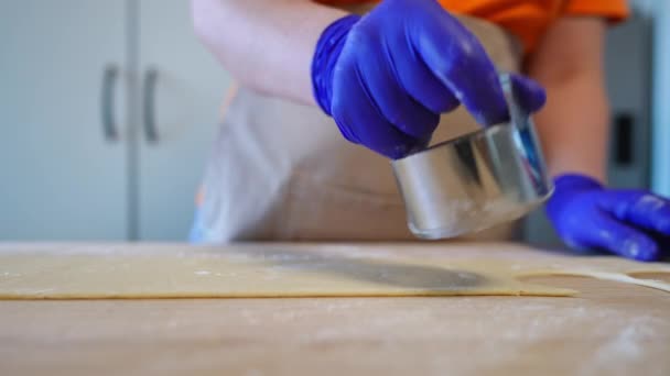 女性白种人手戴手套 用圆形切面刀切面团 在室内厨房里准备饺子配料的不明女人 — 图库视频影像