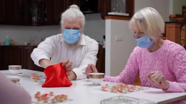Bělošský Starší Pár Covid Masky Hrát Stolní Lotto Přáteli Uvnitř — Stock video