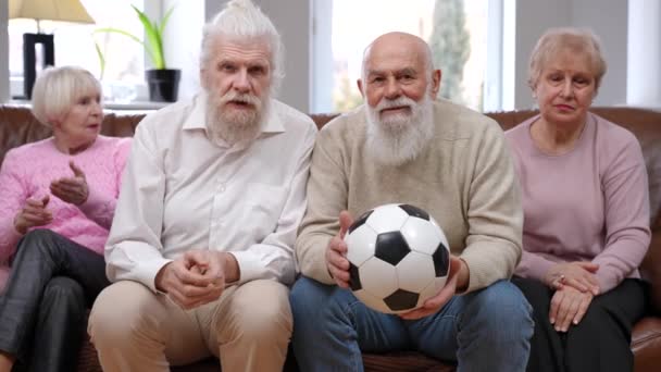 Excited Senior Men Cheering Watching Football Match Bored Women Sitting — Stock Video