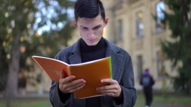 Zoom Focused Caucasian Young Man Reading Exercise Book Turning Page — Stock Video