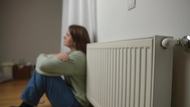 Home Radiator Blurred Young Woman Sitting Floor Background Rubbing Arms — Stock Video