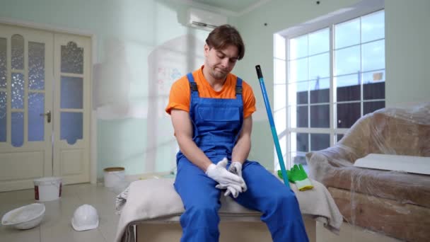 Young Handsome Caucasian Man Overalls Taking Gloves Sighing Sitting Living — Stock Video