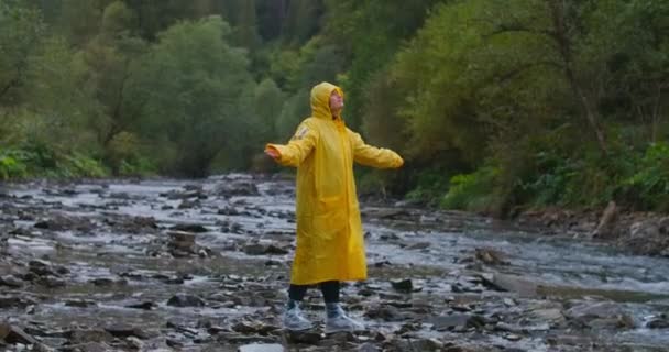 Happy Young Woman Yellow Rain Coat Standing Mountain Stream Raising — Stock Video