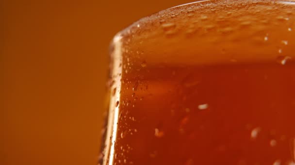 Primer Plano Parte Superior Vaso Cerveza Con Bebida Fondo Naranja — Vídeos de Stock